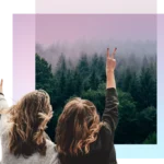 two women giving peace signs at a forest