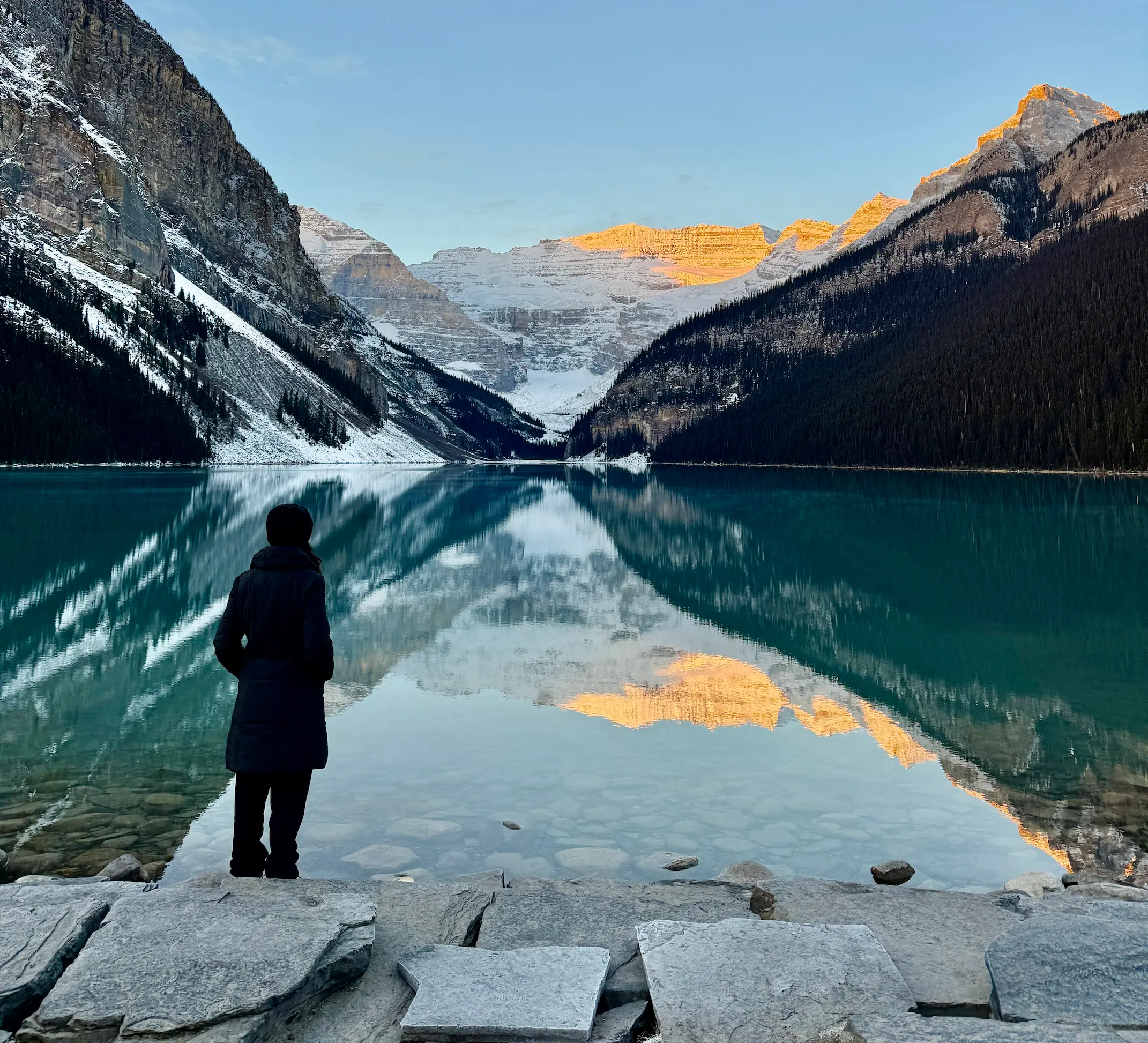 person looking out over glacial lake